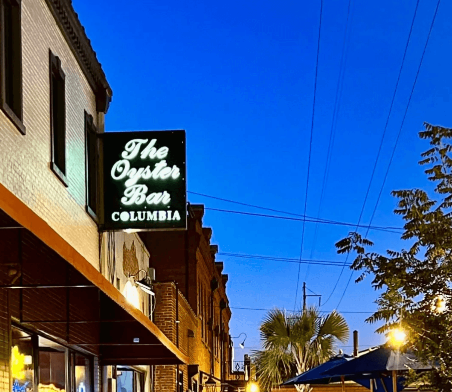 The exterior of The Oyster Bar with bright signage against a twilight sky. The exterior of The Oyster Bar with bright signage against a twilight sky.
