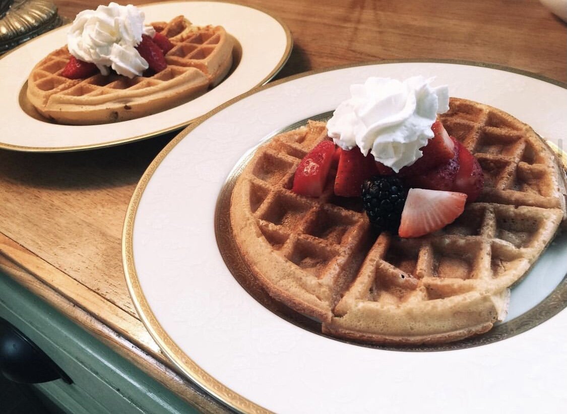 Waffles topped with fresh fruit and whip